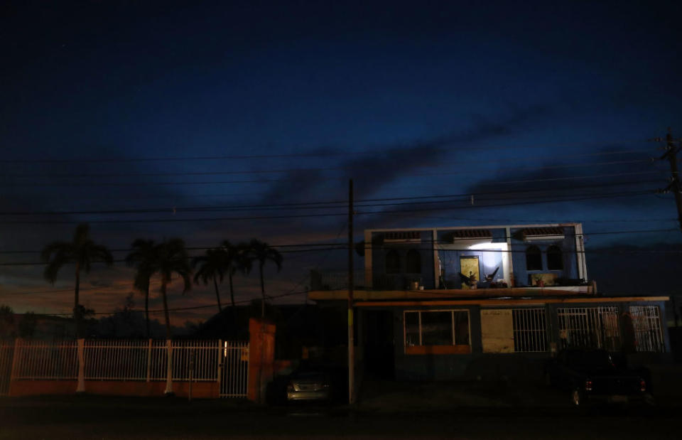 A man uses a battery-operated light in Puerto Rico during the extensive power outage.