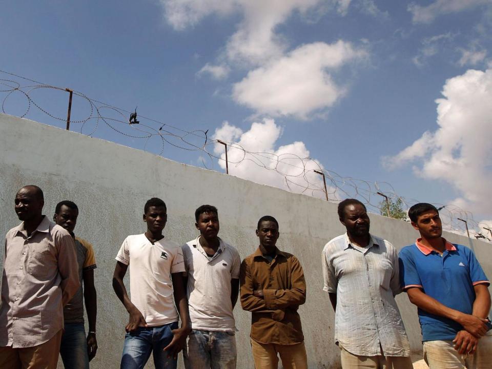 Migrants wait to receive aid distribution provided by the International Organization for Migration in Libya (AFP/Getty Images)