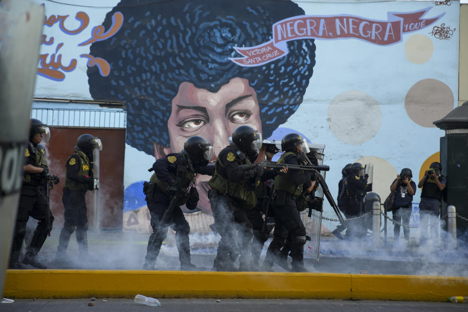 Police clash with anti-government protesters in Lima, Peru, Tuesday, Jan. 24, 2023. Protesters are seeking the resignation of President Dina Boluarte, the release from prison of ousted President Pedro Castillo, immediate elections and justice for demonstrators killed in clashes with police. (AP Photo/Guadalupe Pardo)