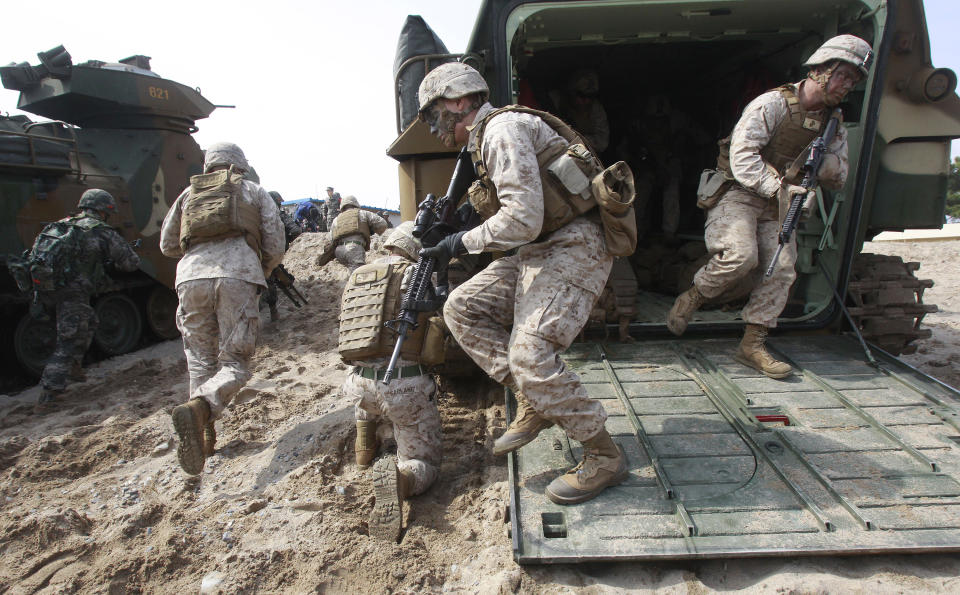 U.S. Marines run out from a South Korean LVT-7 during the U.S.-South Korea joint landing exercises called Ssangyong, part of the Foal Eagle military exercises in Pohang, South Korea, Monday, March 31, 2014. South Korea said North Korea has announced plans to conduct live-fire drills near the rivals' disputed western sea boundary. The planned drills Monday come after an increase in threatening rhetoric from Pyongyang and a series of rocket and ballistic missile launches in an apparent protest against the annual military exercises by Seoul and Washington. (AP Photo/Ahn Young-joon)