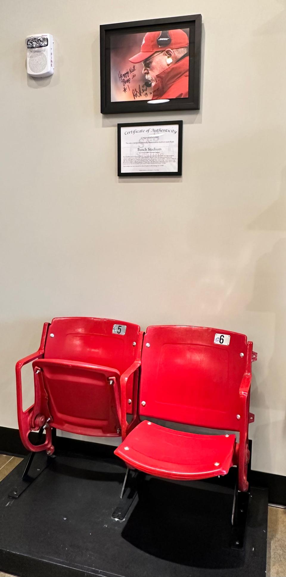 An autographed photo of Andy Reid, head coach of the Kansas City Chiefs, hangs above two stadium seats at the new Heggy's Nut Shop in the Hall of Fame Village.