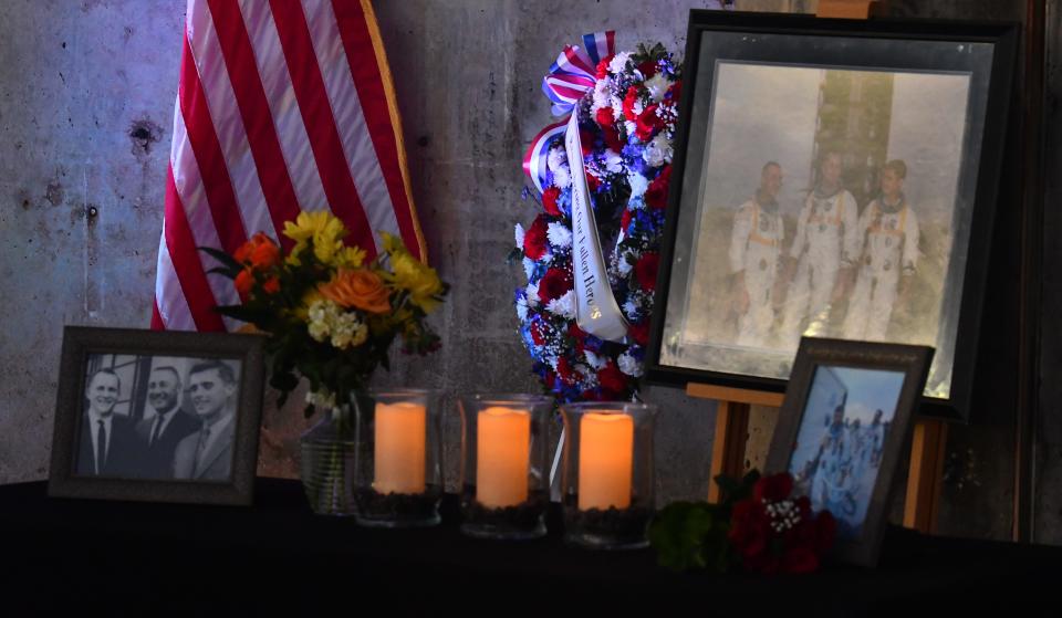 Memorial items adorn the base of the concrete pedestal at Launch Complex 34.