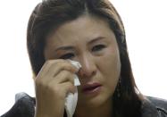 FILE - In this April 11, 2014, file photo, Won Jeong-hwa wipes tears during an interview at her apartment in Gunpo, South Korea. Won, who entered South Korea around 2001 by posing as a defector from the North, was arrested and sentenced to five years in prison in 2008. South Korean authorities said she used sex to extract sensitive information from South Korean military officers and plotted to kill other officers. The South Korean media quickly dubbed her "North Korea's Mata Hari" after the exotic dancer sent to obtain military secrets in World War I. (AP Photo/Lee Jin-man, File)