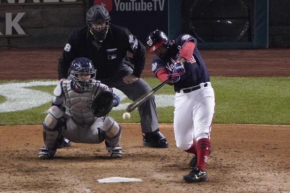 Washington Nationals' Howie Kendrick hits a single during the eighth inning of Game 3 of the baseball World Series against the Houston Astros Friday, Oct. 25, 2019, in Washington. (AP Photo/Alex Brandon)