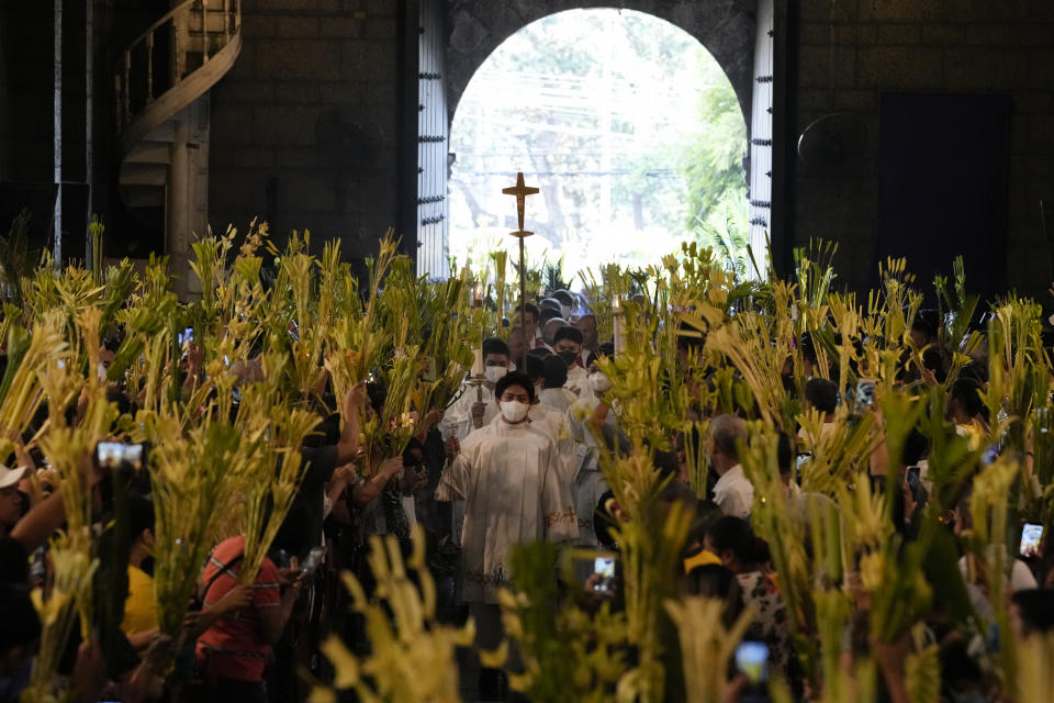 Catholic devotees wave their palm fronds during rites to commemorate Palm Sunday, which marks the entry of Jesus Christ into Jerusalem, Sunday, April 2, 2023 in Manila, Philippines. More devotees have flocked to churches after COVID restrictions the past couple of years prevented many from joining traditional Palm Sunday rites as this largely Roman Catholic nation enters the observance of Holy Week. (AP Photo/Aaron Favila)