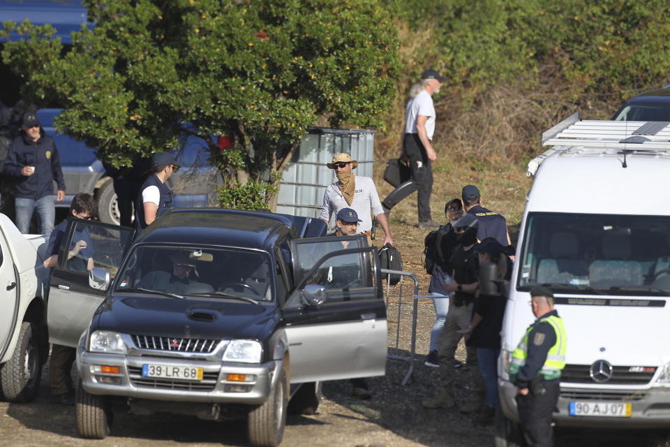 Police search teams set out from an operation tent near Barragem do Arade, Portugal, Wednesday May 24, 2023. Portuguese police aided by German and British officers have resumed their search for Madeleine McCann, the British child who disappeared in the country's southern Algarve region 16 years ago. Some 30 officers could be seen in the area by the Arade dam, about 50 kilometers (30 miles) from Praia da Luz, where the 3-year-old was last seen alive in 2007. (AP Photo/Joao Matos)