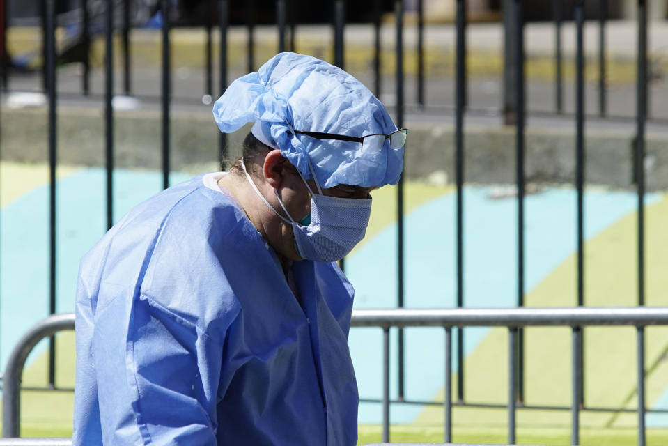 A healthcare worker in personal protective equipment (PPE) walks outside Elmhurst Hospital during the outbreak of the coronavirus disease (COVID-19) in the Queens borough of New York City, New York, U.S., April 6, 2020. REUTERS/Eduardo Munoz