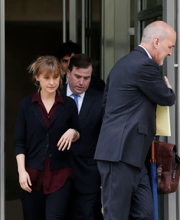 Actor Allison Mack, known for her role in the TV series 'Smallville', exits with her lawyers following a hearing on charges of sex trafficking in relation to the Albany-based organization Nxivm at United States Federal Courthouse in Brooklyn, New York, U.S., May 4, 2018. REUTERS/Brendan McDermid