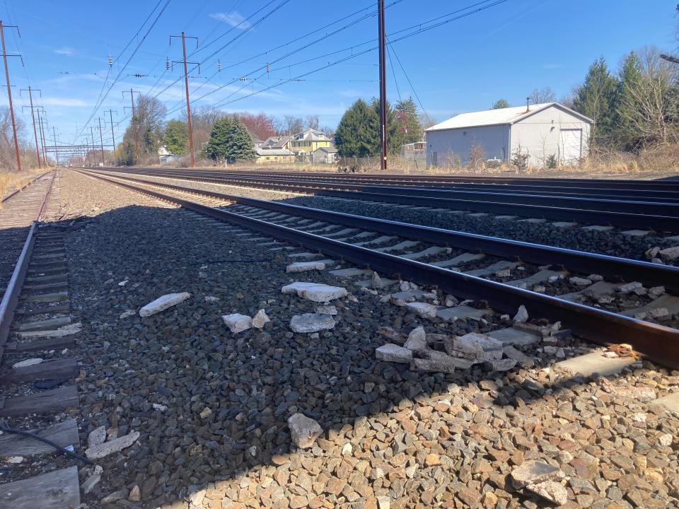 Chunks of concrete from the underside of the Edgely bridge lay alongside southbound tracks in Bristol Township. The bridge was closed after a second train was struck by falling debris, said township Manager Randee Elton.