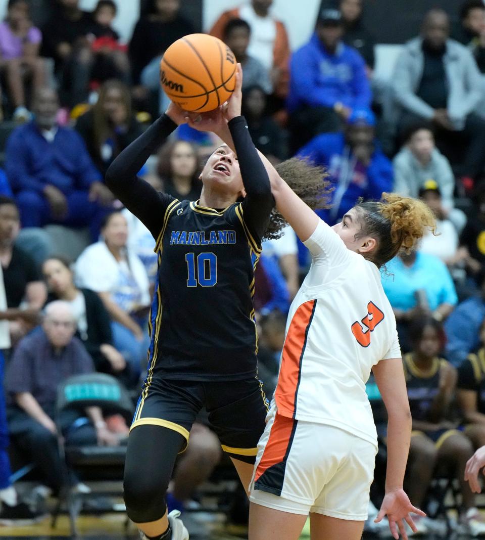 Mainland's Tia Dobson (10) gets fouled by Spruce Creek's Lillian Sanchez (3) during the Five Star Conference Tournament finals at Atlantic High School in Port Orange, Friday, Jan. 26, 2024.