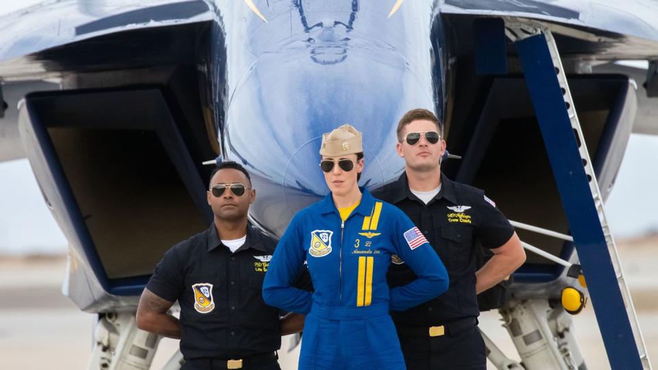 After completing her first public air show performance as a Blue Angel pilot, Lt. Amanda Lee poses with her crew in front of her F/A-18E/F Super Hornet.  (Alan de Herrera/Special to Navy Times)