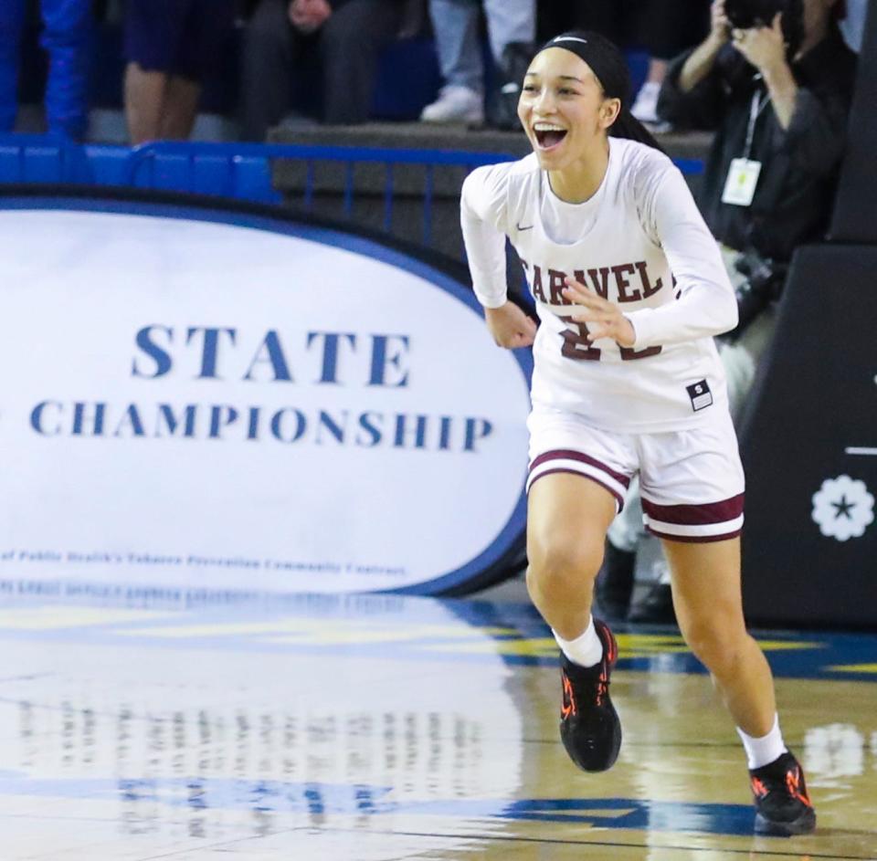 Caravel's India Johnston rushes to celebrate with her teammates after the final whistle in Caravel's 53-47 win against Sanford in the DIAA state tournament championship game Friday, March 11, 2022 at the Bob Carpenter Center.