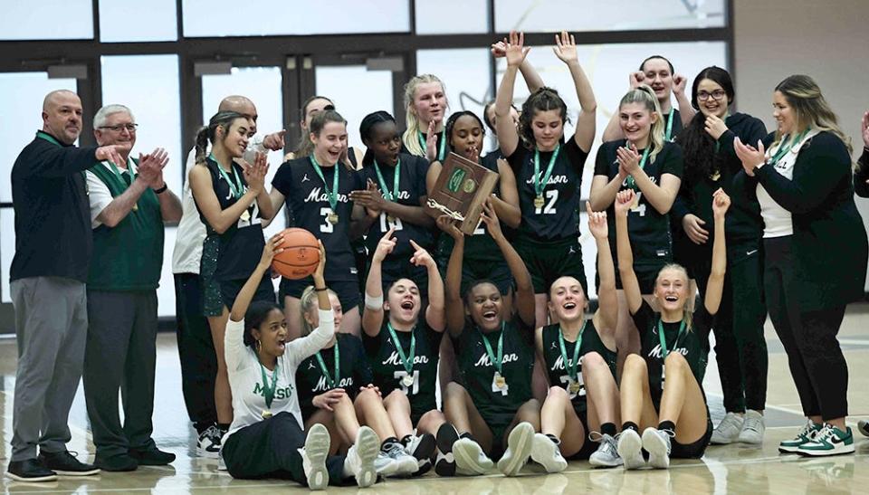 Mason girls basketball team celebrates winning the Division I district championship over Centerville Saturday, March 2, 2024.