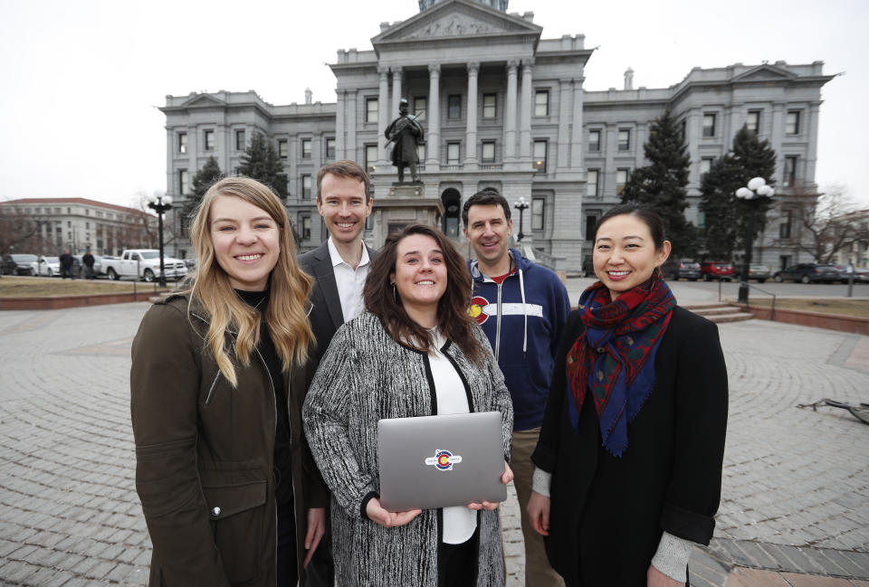 In this Tuesday, Jan. 21, 2020, photograph, from left, Stephanie Cain, Matthew McAllister, Janell Schafer, Kelly Taylor and Yeri Kim, members of the Colorado Digital Service, are shown outside the State Capitol in downtown Denver. (AP Photo/David Zalubowski)