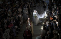 <p>Meghan walks down the aisle on her wedding day. Father-in-law Prince Charles accompanied her halfway (Getty) </p>