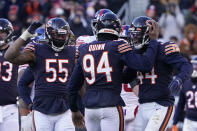 Chicago Bears outside linebacker Robert Quinn (94) celebrates with teammates Bruce Irvin (55) and Alec Ogletree, Quinn's strip-sack of New York Giants quarterback Mike Glennon, setting a new team record for sacks in a season, during the second half of an NFL football game Sunday, Jan. 2, 2022, in Chicago. The Bears won 29-3. (AP Photo/David Banks)