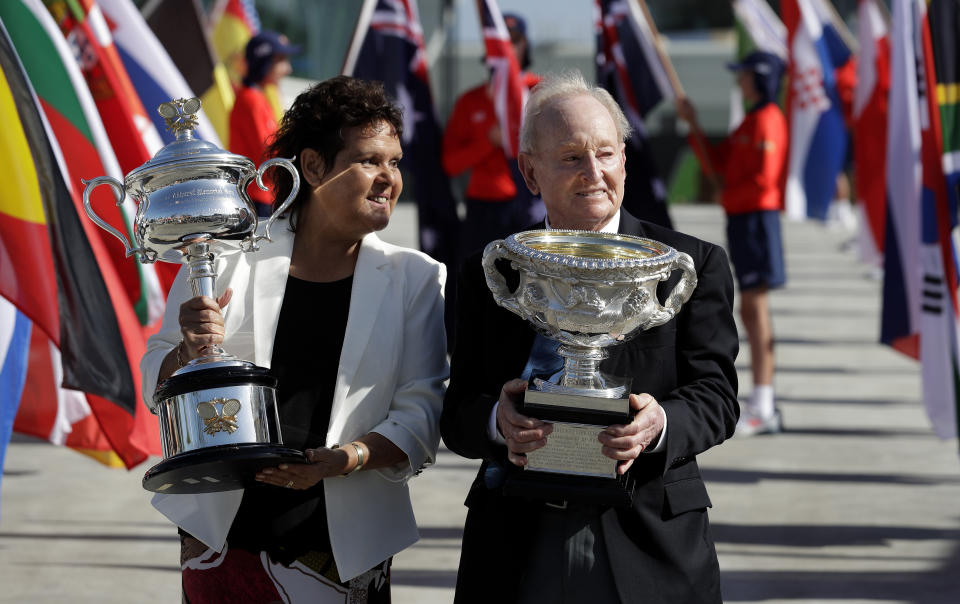 Australian tennis legends Evonne Goolagong Cawley and Rod Laver hold the women's and men's trophies, the Daphne Akhurst Memorial Cup and the Norman Brookes Challenge Cup at the official start of the Australian Open tennis championships in Melbourne, Australia, Monday, Jan. 14, 2019. (AP Photo/Aaron Favila)