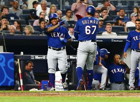 Aug 10, 2018; Bronx, NY, USA; Texas Rangers Texas Rangers first baseman Ronald Guzman (67) is congratulated by left fielder Willie Calhoun (5) after hitting his third home run against the New York Yankees during the seventh inning at Yankee Stadium. Mandatory Credit: Andy Marlin-USA TODAY Sports