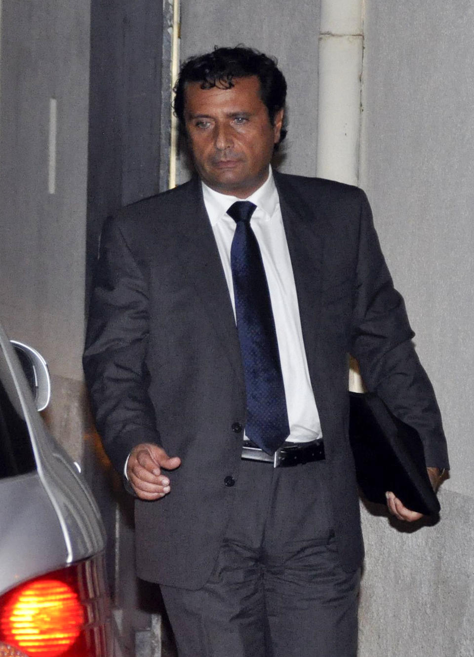 Captain Francesco Schettino leaves after an audience of his trial at the converted Teatro Moderno theater, in Grosseto, Italy, Monday, Oct. 28, 2013. The captain of the wrecked Costa Concordia is charged with manslaughter, causing the shipwreck and abandoning ship before the luxury cruise liner's 4,200 passengers and crew could be evacuated on Jan. 13, 2012 when the ship collided with a reef off the Tuscan island of Giglio, killing 32 people. (AP Photo/Giacomo Aprili)