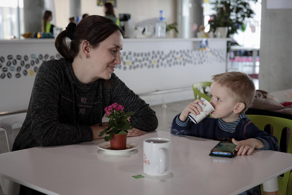 Elena Litvinova, 33 years old, accountant from Mykolaiv, Ukraine, smiles at her 3 year-old son, Artem, after an interview with The Associated Press at a refugee center in Brasov, Romania, Wednesday, March 30, 2022. The number of Ukrainians who have fled the Russian war reached the dramatic new landmark of 4 million people, the United Nations announced Wednesday, as Moscow kept up its attacks — even in places where it had vowed to ease its military operations. (AP Photo/Stephen McGrath)