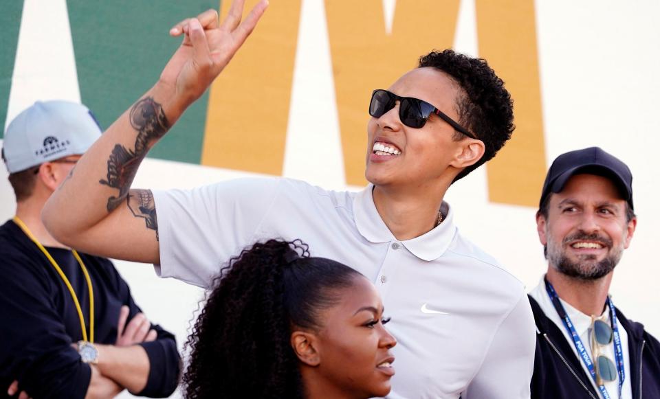 American professional basketball player Brittney Griner acknowledges fans as she watches on the 16th hole during the third round of the WM Phoenix Open golf tournament, Feb. 11, 2023, in Scottsdale, Ariz.