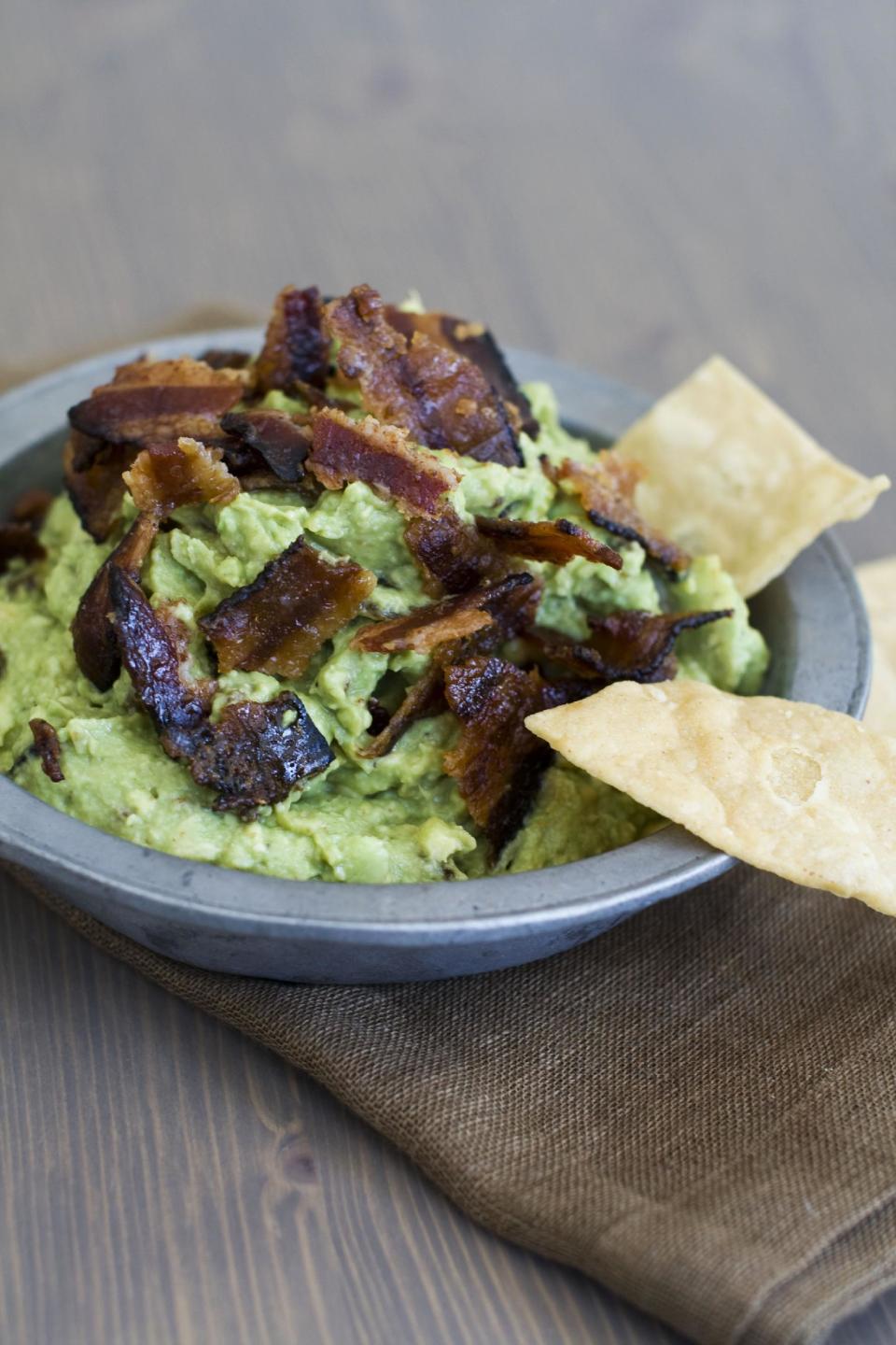 In this image taken on January 7, 2013, sweet heat bacon guacamole is shown served in a bowl in Concord, N.H. (AP Photo/Matthew Mead)