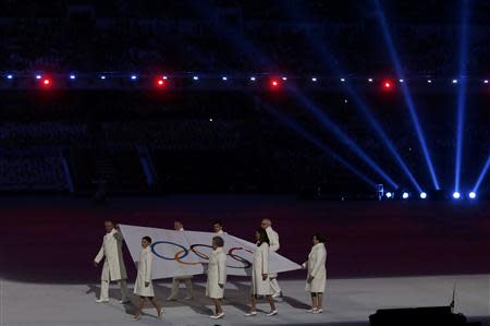 The Olympic flag is carried into the stadium during the opening ceremony of the 2014 Sochi Winter Olympics, February 7, 2014. REUTERS/Phil Noble