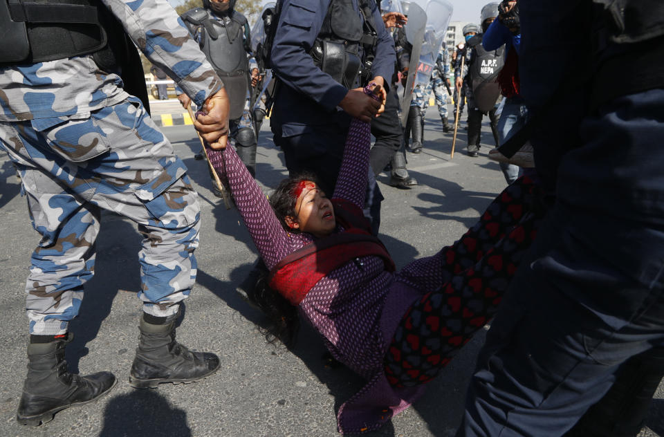 A pro-king supporter injured during clash with riot police is carried away as they march demanding reinstating monarchy that was abolished more than a decade ago in Kathmandu, Nepal, Monday, Jan.11, 2021. Monday's protest was the latest anti-government protest against Prime Minister Khadga Prasad Oli who has been facing street demonstrations against him from a splinter faction of his own Communist party and more from opposition political groups for dissolving parliament. Nepal's centuries-old monarchy was abolished in 2008 by the parliament and replaced by a republic where the president was elected as the head of state. (AP Photo/Niranjan Shrestha)