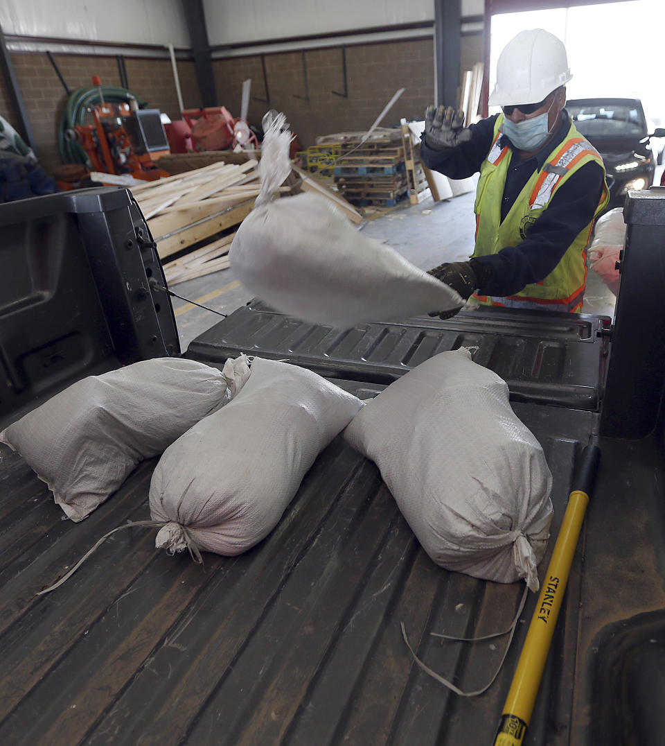 Hidalgo County Precinct 4 employees load sand bags in anticipation of the Tropical Storm Hanna on Friday, July,24, 2020, in Edinburg, Texas. A Tropical Storm warning remains in effect for parts of the Rio Grande Valley, the National Weather Service is reporting. (Delcia Lopez/The Monitor via AP)