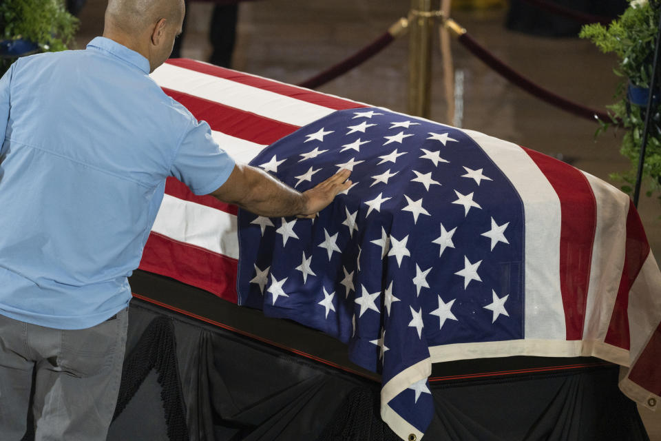 Capitol Police Sgt. Aquilino Gonell, pays his respects as the flag-draped casket bearing the remains of Hershel W. "Woody" Williams, lies in honor in the U.S. Capitol, Thursday, July 14, 2022 in Washington. Williams, the last remaining Medal of Honor recipient from World War II, died at age 98.(Eric Lee/Pool photo via AP)