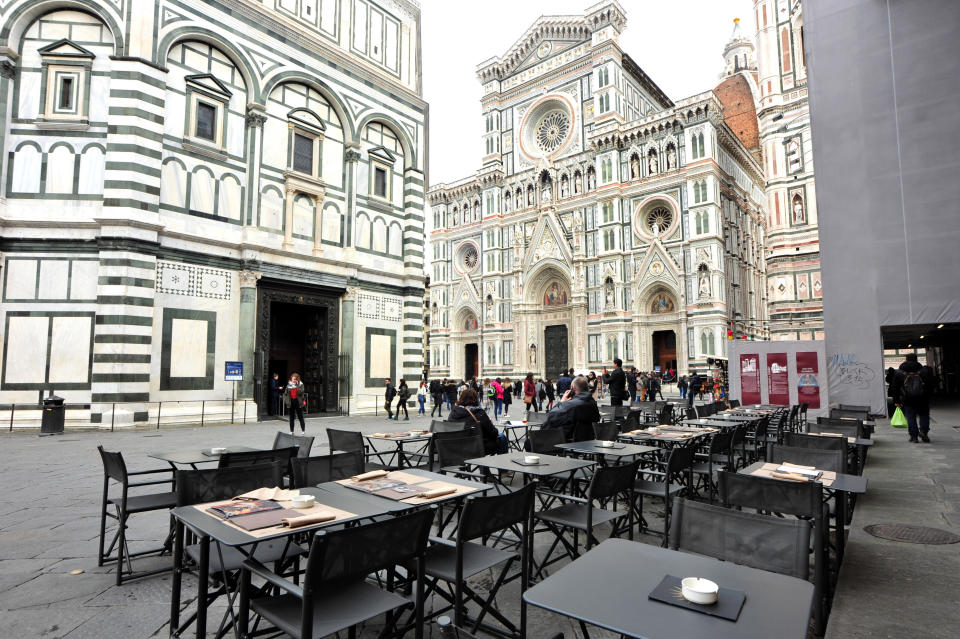 A cafe' is empty in Piazza del Duomo square, in Florence, Italy, Tuesday, March 10, 2020. Italy entered its first day under a nationwide lockdown after a government decree extended restrictions on movement from the hard-hit north to the rest of the country to prevent the spreading of coronavirus. (Jennifer Lorenzini/LaPresse via AP)