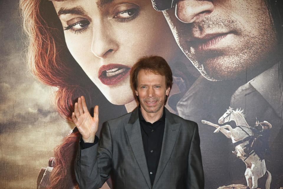 FILE - In this July 24, 2013 file photo, Producer Jerry Bruckheimer poses for photographers as he arrives at the cinema for the French premiere of the Disney film, "The Lone Ranger," in Paris, France. After more than two decades with Disney, where he produced the juggernaut “Pirates of the Caribbean” and “National Treasure” film franchises among many box-office hits, Bruckheimer begins a new partnership with Paramount in March 2014. (AP Photo/Francois Mori, File)