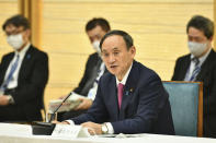 Japanese Prime Minister Yoshihide Suga speaks during a meeting of the coronavirus infection control headquarters at his office in Tokyo Friday, Jan. 22, 2021. Suga, in a speech earlier, said the vaccine is “the clincher” in the fight against the pandemic and vowed to start vaccinations as soon as late February, when a health ministry approval of the Pfizer vaccine, the first applicant, is expected. (Kazuhiro Nogi/Pool Photo via AP)