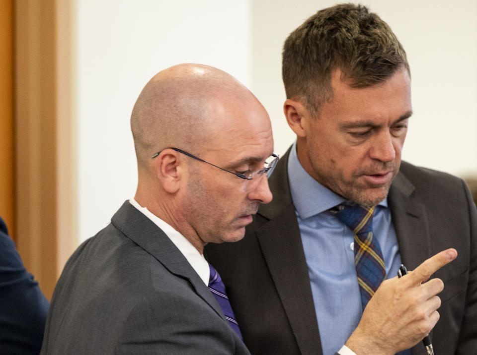 Defense attorneys Jared Ausserer,left, and Casey Arbenz talk during the trial of Tacoma Police Officers Christopher Burbank, Matthew Collins and Timothy Rankine in the killing of Manny Ellis at Pierce County Superior Court, Tuesday, Oct. 10, 2023, in Tacoma, Wash. (Brian Hayes/The News Tribune via AP, Pool)