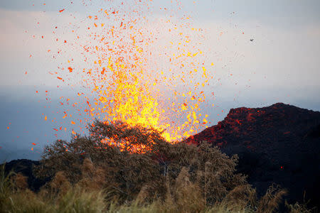 Lava erupts on the outskirts of Pahoa during ongoing eruptions of the Kilauea Volcano in Hawaii, U.S., May 19, 2018. REUTERS/Terray Sylvester