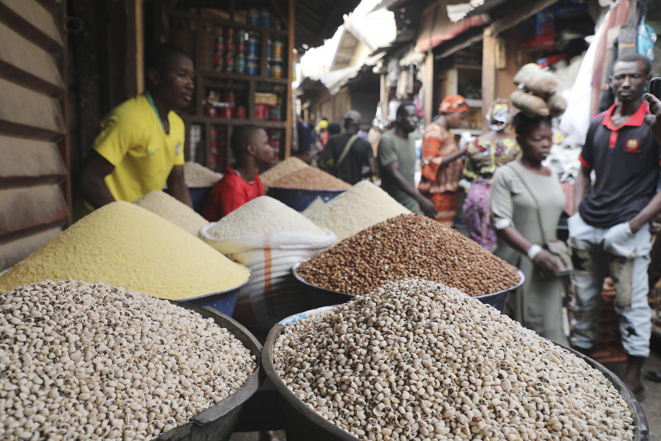 Pedestrian shop for food items at the Mile 12 Market in Lagos, Nigeria, Friday, Feb. 16, 2024. Nigerians are facing one of the West African nation's worst economic crises in as many years triggered by a surging inflation rate which follows monetary policies that have dipped the local currency to an all-time low against the dollar, provoking anger and protests across the country. (AP Photo/Mansur Ibrahim)