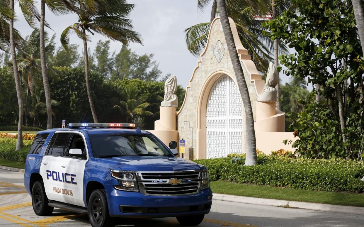 Police at the entrance of Donald Trump's house at Mar-a-Lago in Palm Beach, Florida, on Aug 9 following an FBI search the previous day - Eva Marie Uzcategui /Bloomberg