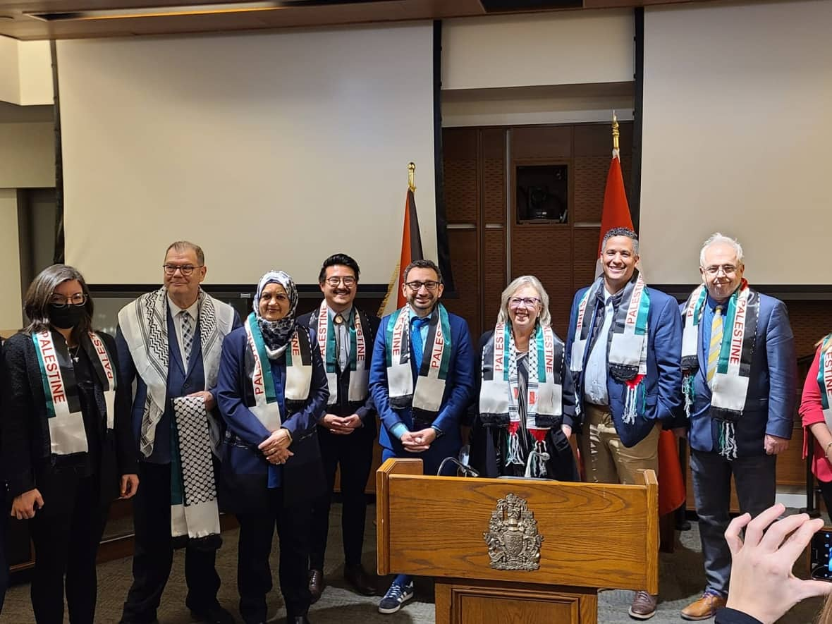 A number of MPs attended an International Day of Solidarity with the Palestinian People event on Parliament Hill on Tuesday. From left to right: Liberal MP Sameer Zuberi, NDP MP Niki Ashton, Bloc Québécois MP Mario Beaulieu, Liberal MP Salma Zahid, NDP MP Blake Desjarlais, Transport Minister Omar Alghabra, Green Party Leader Elizabeth May, NDP MP Matthew Green, Bloc Québécois MP Denis Trudel, NDP MP Lindsay Mathyssen. (Nazih Khatatba/Facebook - image credit)