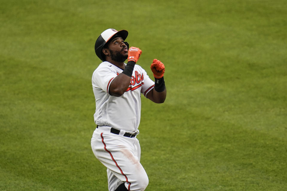 Baltimore Orioles' Maikel Franco reacts while running the the bases after hitting a two-run home run off New York Yankees relief pitcher Wandy Peralta (58) during the seventh inning of a baseball game, Sunday, May 16, 2021, in Baltimore. Orioles' Pedro Severino scored on the play. (AP Photo/Julio Cortez)