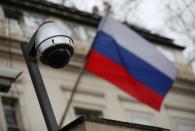 FILE PHOTO: A security camera is seen, and a flag flies outside the consular section of Russia's embassy in London