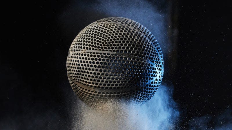 Wilson's 3D-printed airless basketball prototype photographed bouncing in white powder against a black background.