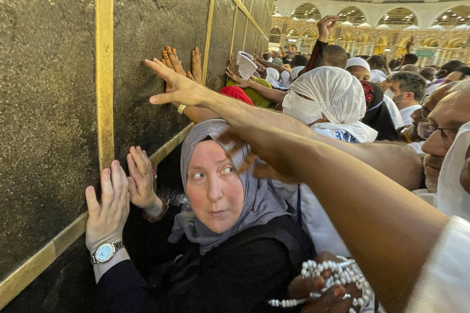 Muslim pilgrims pray in front of the Kaaba, the cubic building at the Grand Mosque, during the annual hajj pilgrimage, in Mecca, Saudi Arabia, Sunday, June 25, 2023. Muslim pilgrims are converging on Saudi Arabia's holy city of Mecca for the largest hajj since the coronavirus pandemic severely curtailed access to one of Islam's five pillars. (AP Photo/Amr Nabil)