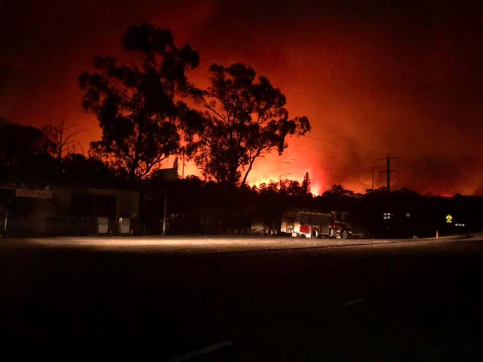 An image shows a bushfire near Nowa Nowa general store in Nowa Nowa, East Gippsland.