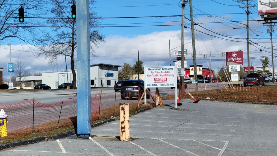 A sign where a new entrance is being constructed at Henderson Crossing Plaza on Four Seasons Boulevard tells drivers that spaces are available.
