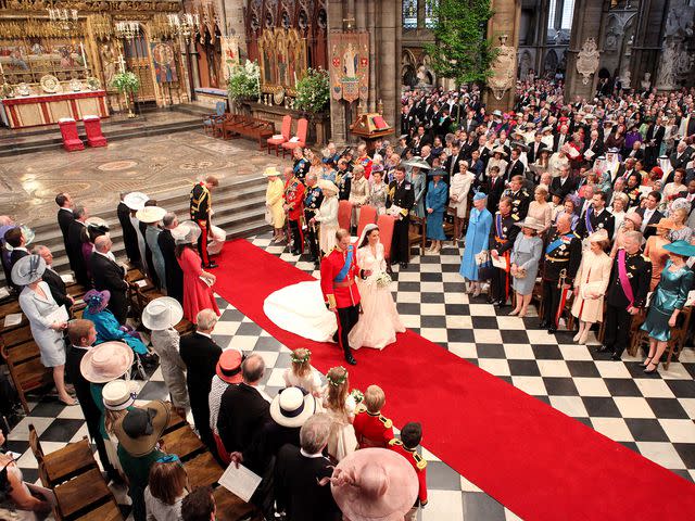 <p>Dominic Lipinski - WPA Pool/Getty</p> Prince William and Kate Middleton walking down the aisle at their wedding