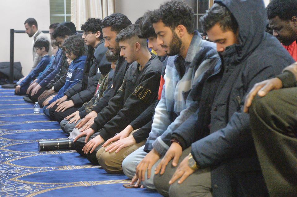 Muslim men pray at the Erie Masjid prior to iftar, the meal breaking their daily fast, during the Islamic holy month of Ramadan in 2023. Muslim men and women fast from sunup to sundown during Ramadan.