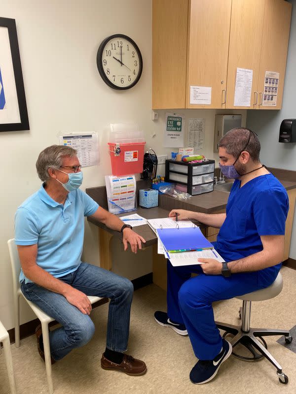 Volunteer prepares to have his blood drawn as part of a Phase 1 clinical trial for a COVID-19 vaccine at Emory University in Atlanta