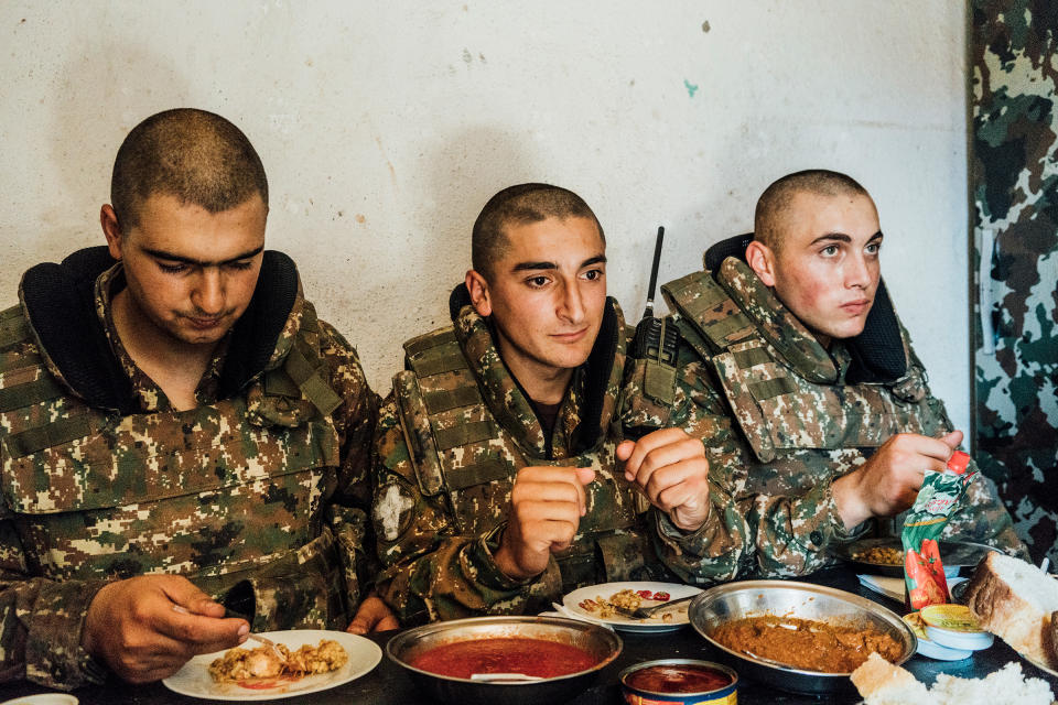 Armenian soldiers eat their rations inside a bunker on a frontline position near the town of Askeran.<span class="copyright">Emanuele Satolli</span>
