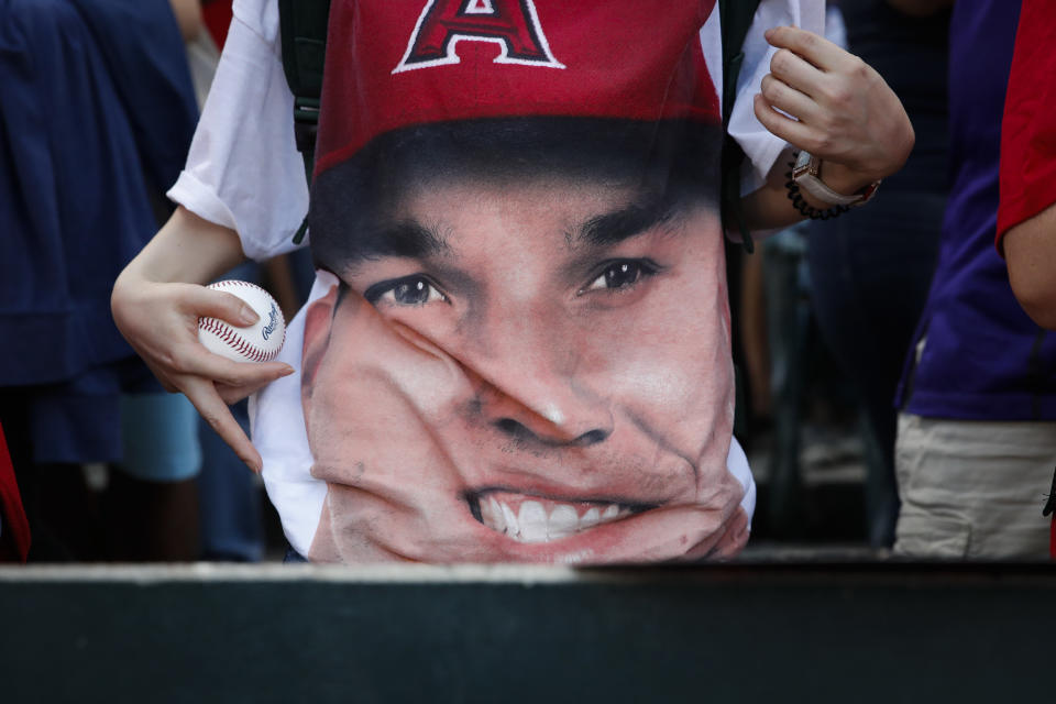 A fan wears a t-shirt with an image of Los Angeles Angels’ Mike Trout before the Angels baseball game with the Seattle Mariners, Wednesday, July 11, 2018, in Anaheim, Calif. (AP)