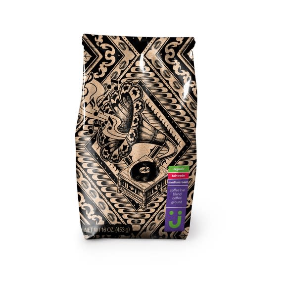 Bag of ground coffee labeled "organic" and "fair trade," in packaging with stylized phonograph and musical notes